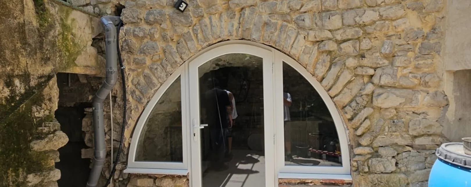 Installation d'une porte d'entrée PVC sur mesure avec imposte cintrée à Moulezan (30350)