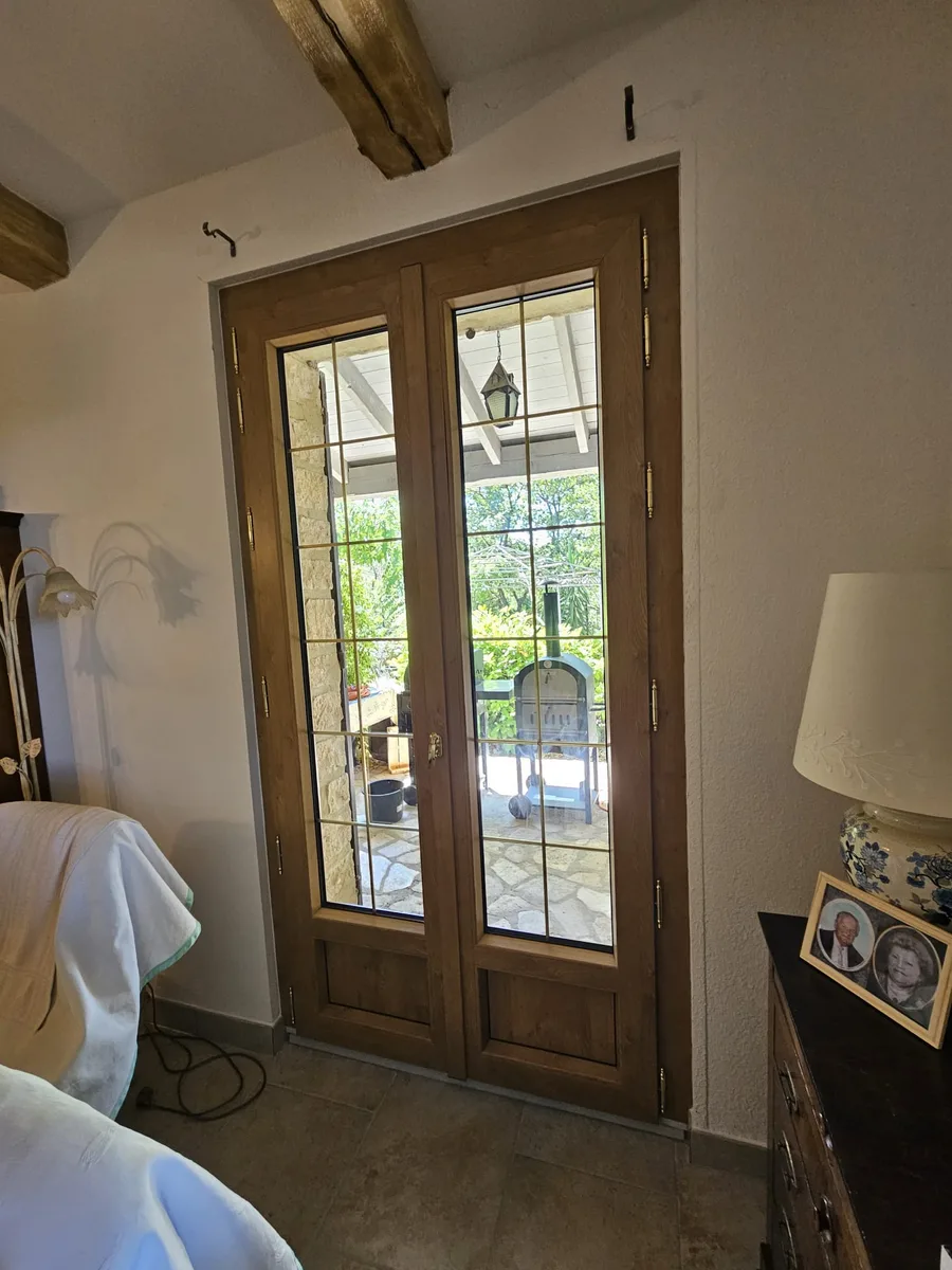 Double porte-fenêtre PVC chêne irlandais vue de l'intérieur d'une pièce à vivre.
